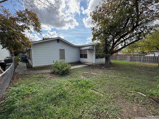 rear view of house with a lawn