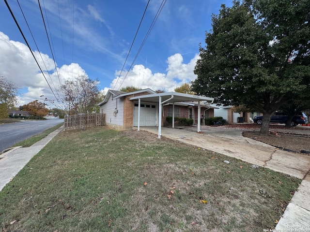 view of front of property with a front lawn and a carport