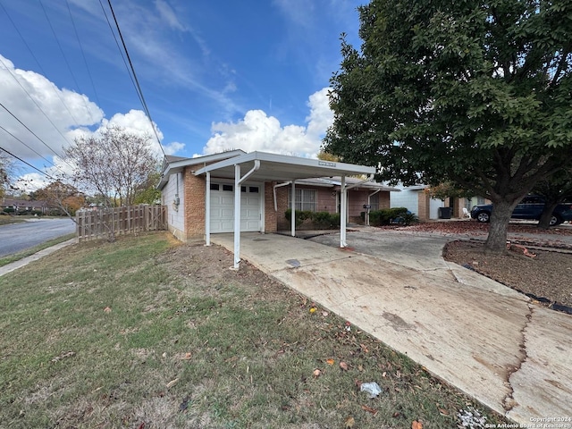 view of front of property featuring a front lawn, a garage, and a carport