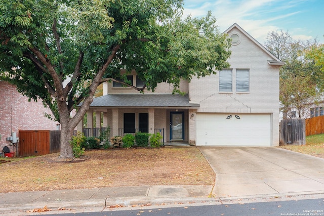 view of front property with a porch and a garage