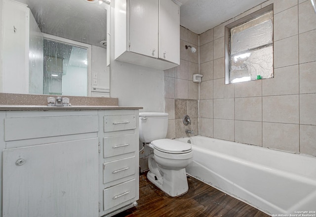 full bathroom featuring toilet, vanity, wood-type flooring, and tiled shower / bath