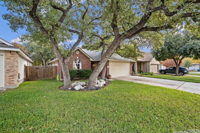 view of front of property featuring a garage and a front lawn