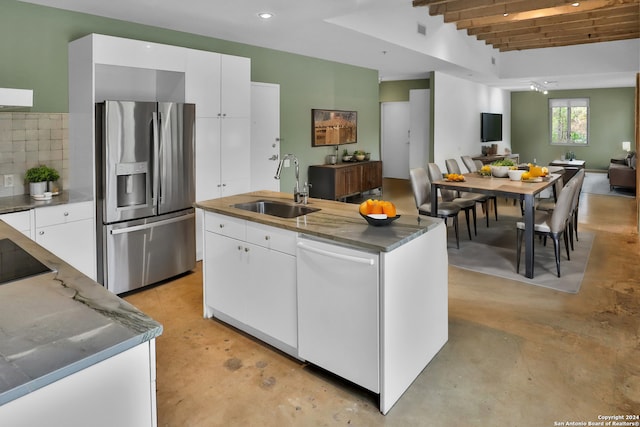 kitchen featuring dishwasher, sink, stainless steel fridge, beamed ceiling, and white cabinetry