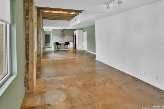 spare room with concrete flooring and track lighting