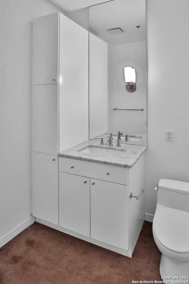 bathroom with vanity and toilet