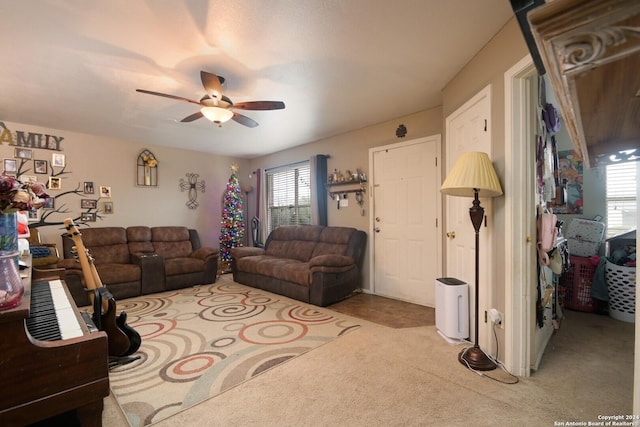 carpeted living room with ceiling fan and a healthy amount of sunlight