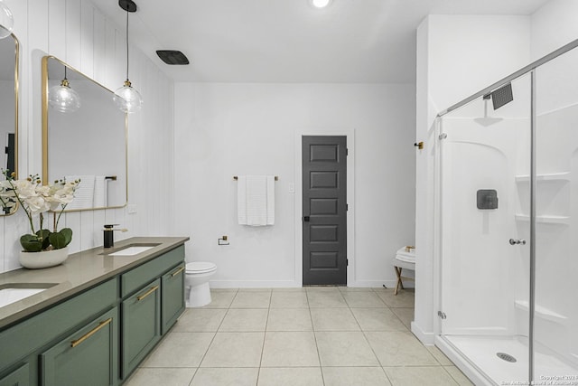 bathroom featuring tile patterned floors, vanity, toilet, and a shower with shower door