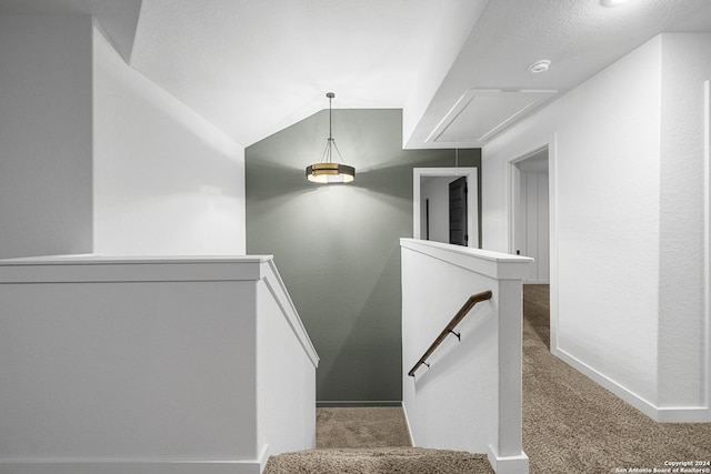 stairs with carpet flooring and lofted ceiling