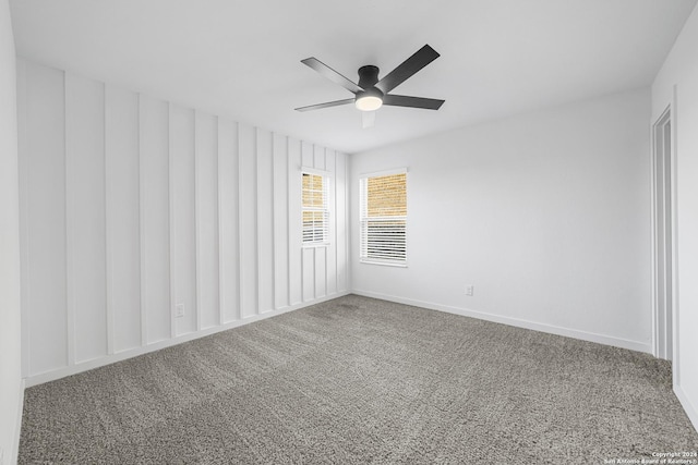 spare room featuring carpet and ceiling fan