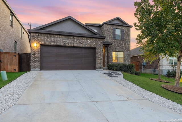 view of front facade with a yard and a garage