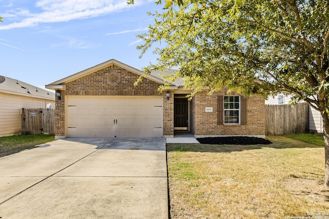 view of front of property featuring a front yard and a garage