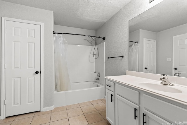 bathroom with tile patterned floors, vanity, a textured ceiling, and shower / tub combo