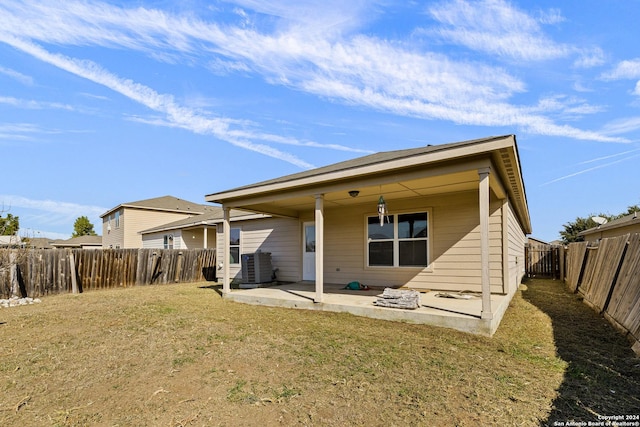 back of house featuring a yard, a patio, and central AC