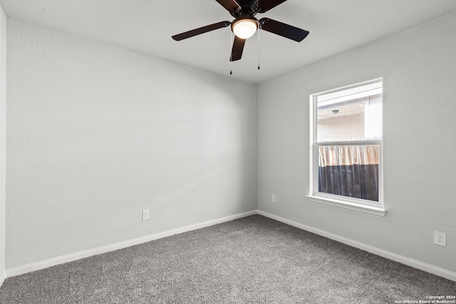 carpeted empty room featuring ceiling fan