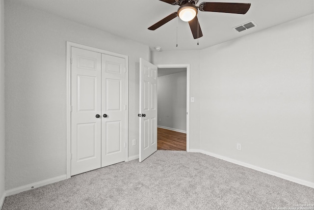 unfurnished bedroom featuring ceiling fan, carpet floors, and a closet