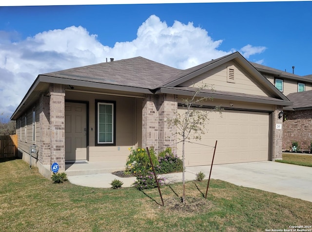 ranch-style house featuring a garage and a front yard