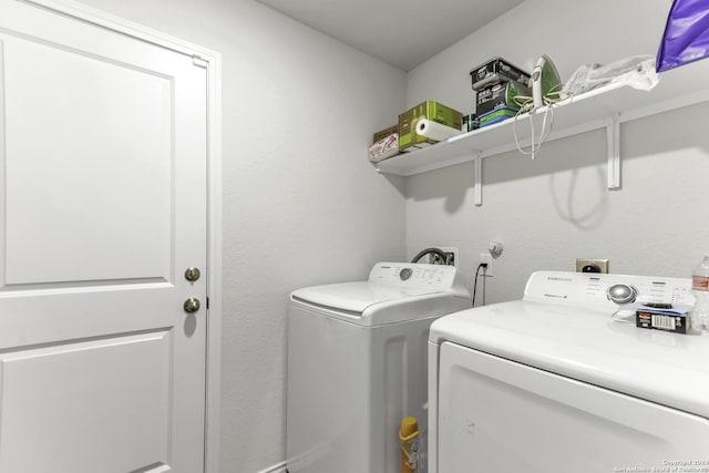 clothes washing area featuring separate washer and dryer