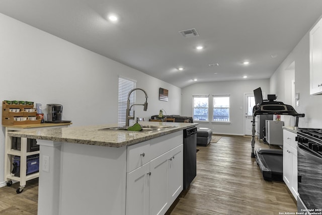 kitchen with white cabinets, a kitchen island with sink, lofted ceiling, and sink