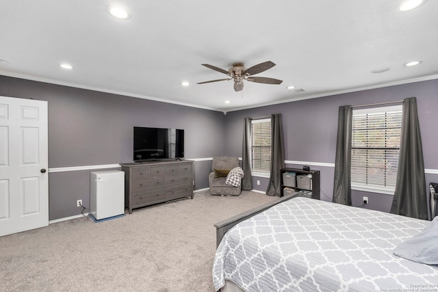 carpeted bedroom featuring ceiling fan and ornamental molding