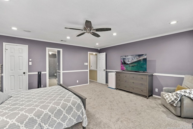 bedroom featuring ceiling fan, light colored carpet, ensuite bathroom, and crown molding