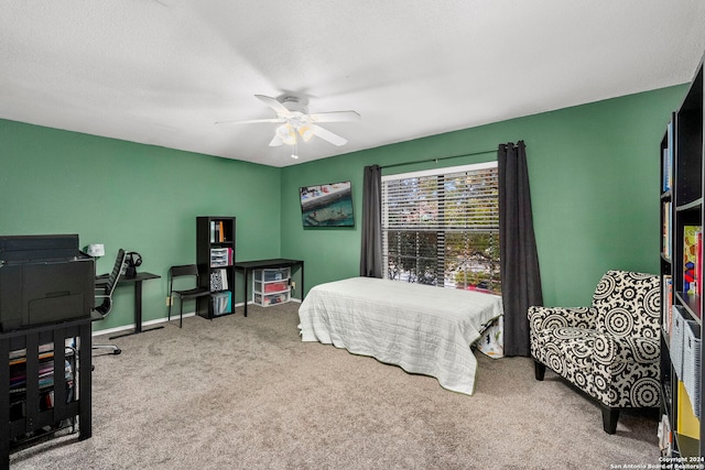 bedroom with ceiling fan, carpet, and a textured ceiling