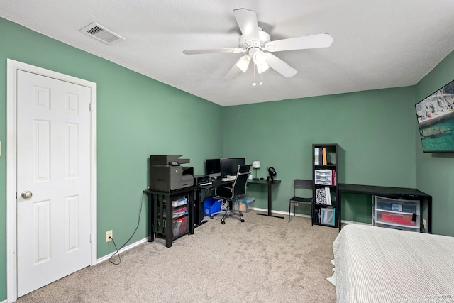 bedroom with light carpet, a textured ceiling, and ceiling fan