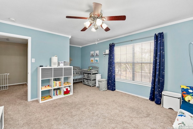 carpeted bedroom featuring a crib, ceiling fan, and crown molding