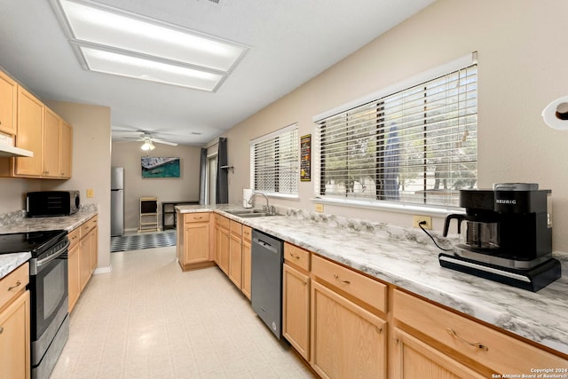 kitchen featuring appliances with stainless steel finishes, light brown cabinets, ceiling fan, and sink