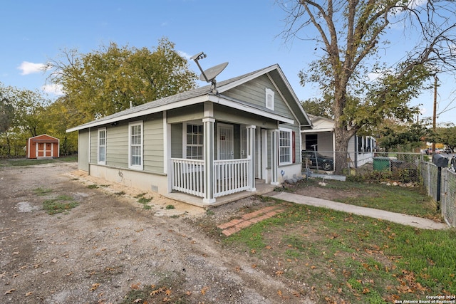 view of front of house featuring covered porch and a storage unit