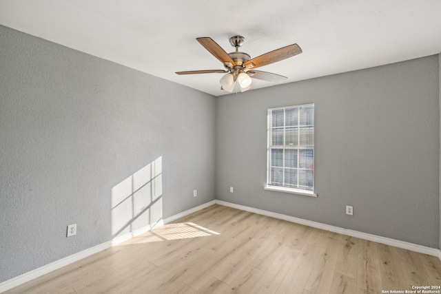 spare room featuring light hardwood / wood-style flooring and ceiling fan