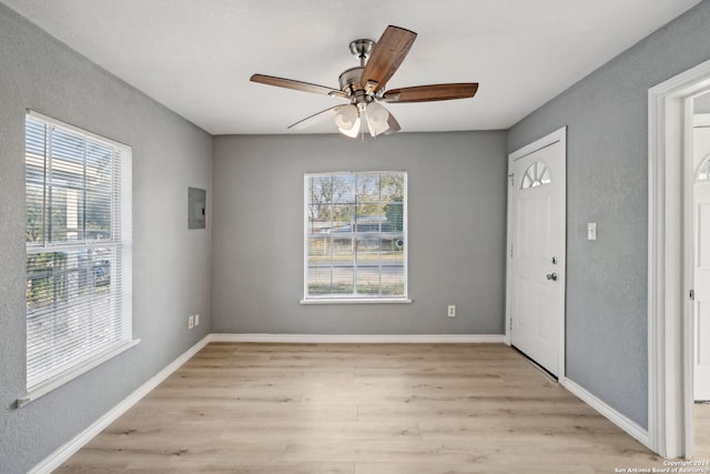 foyer entrance featuring ceiling fan, light hardwood / wood-style floors, and electric panel