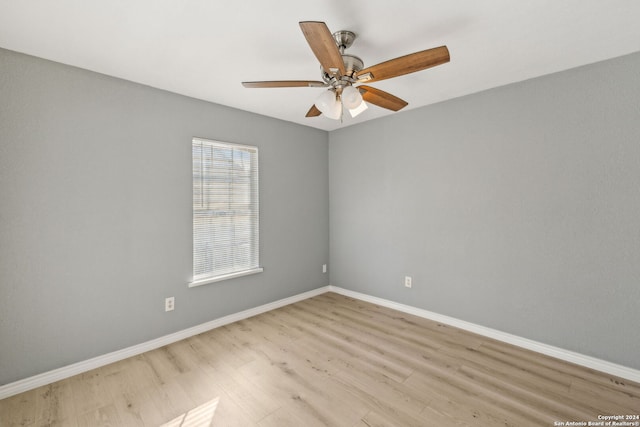 empty room with ceiling fan and light hardwood / wood-style flooring