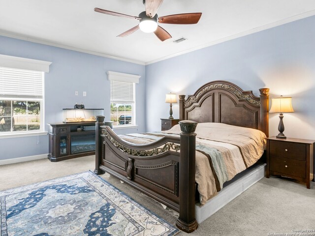 carpeted bedroom featuring multiple windows, ceiling fan, and ornamental molding