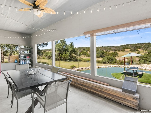 unfurnished sunroom with ceiling fan