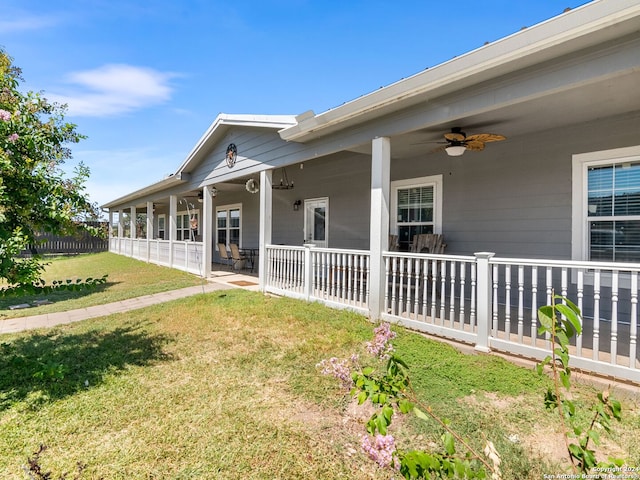 exterior space featuring ceiling fan, a yard, and covered porch