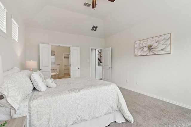 carpeted bedroom featuring ensuite bath, ceiling fan, and lofted ceiling