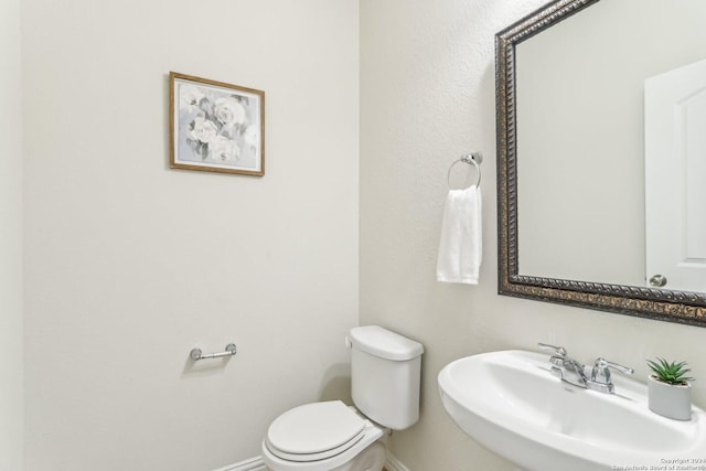 bathroom with toilet and sink