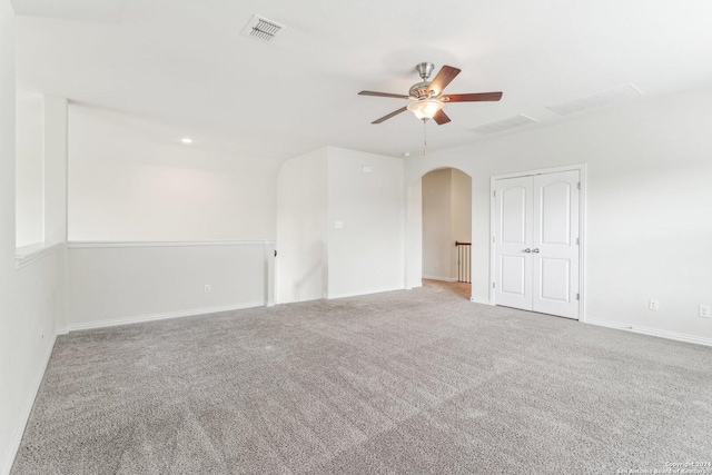 carpeted spare room with ceiling fan