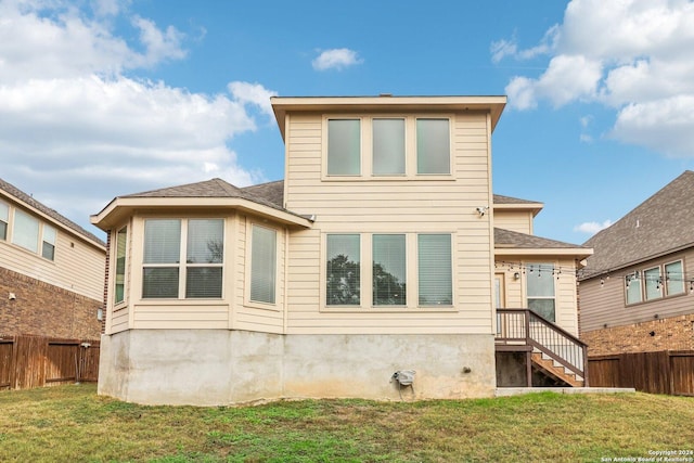 rear view of property with a lawn