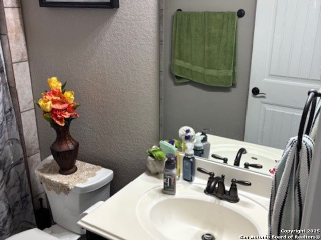 bathroom featuring vanity and toilet