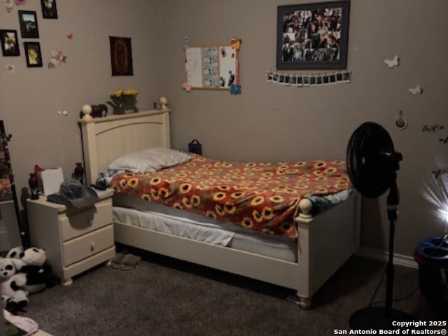 bedroom with dark colored carpet