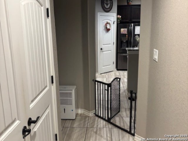 hallway featuring light tile patterned floors