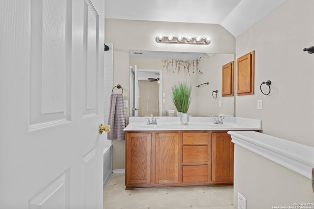 bathroom with vanity and lofted ceiling