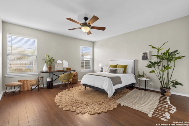 bedroom with ceiling fan and dark hardwood / wood-style flooring