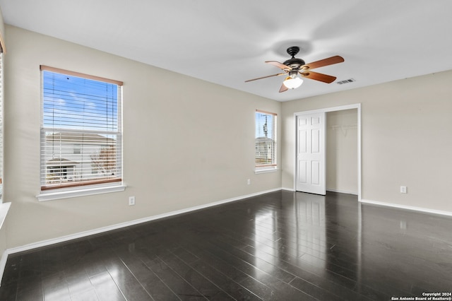 unfurnished room featuring ceiling fan and dark hardwood / wood-style floors