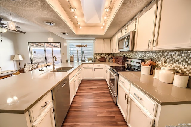 kitchen with sink, white cabinets, stainless steel appliances, and a textured ceiling