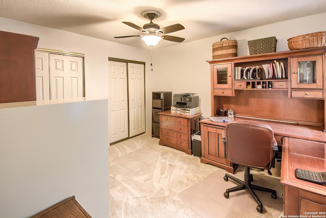 office with light carpet and ceiling fan