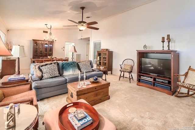 living room with light carpet, ceiling fan with notable chandelier, vaulted ceiling, and ornamental molding