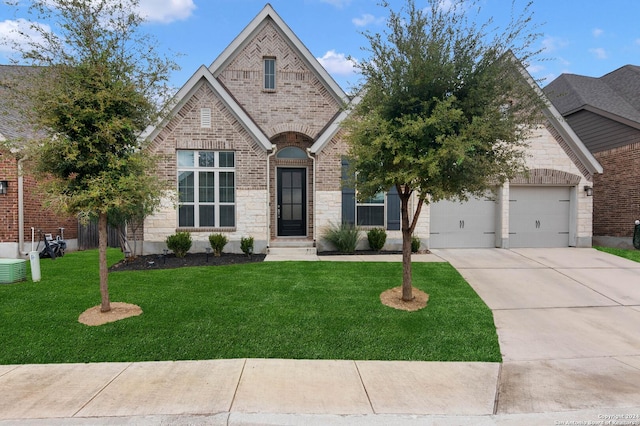 view of front of property featuring a garage and a front yard