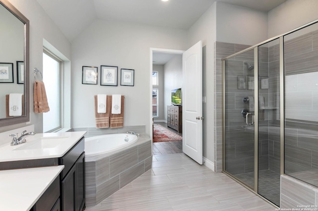 bathroom with vanity, wood-type flooring, lofted ceiling, and plus walk in shower